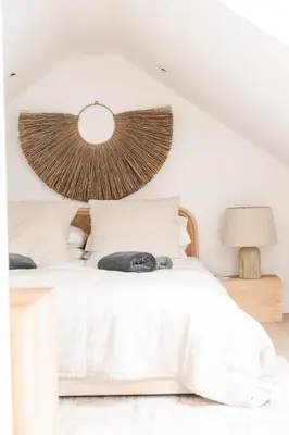 a bedroom with a white bed with a lamp at Lowen Tree House in Truro