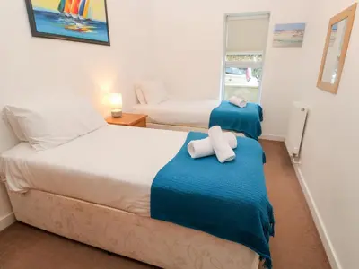 a bedroom with two beds with towels on them at Ocean View in St Ives