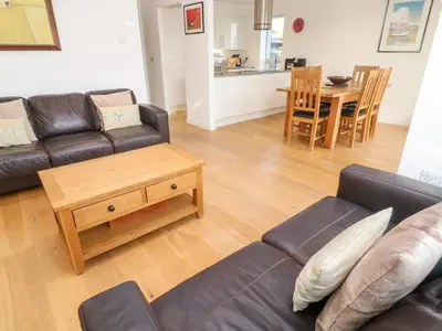 a living room with a couch and a table at Ocean View in St Ives