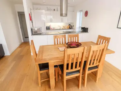 a wooden dining room table and chairs in a kitchen at Ocean View in St Ives