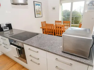 a kitchen with a counter top with a stove top oven at Ocean View in St Ives