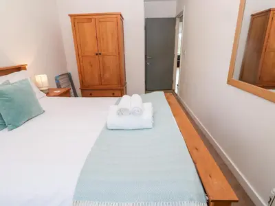 a bedroom with a bed with two towels on it at Ocean View in St Ives