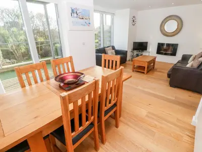 a living room with a wooden table and chairs at Ocean View in St Ives