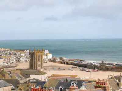 a town with a clock tower and a beach at Ocean View in St Ives
