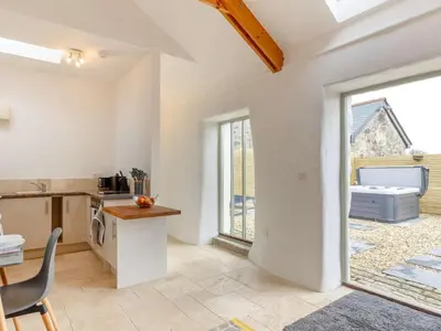 a kitchen with a table and a chair in a room at 1 Bed in Redruth oc-85826 in Gwennap