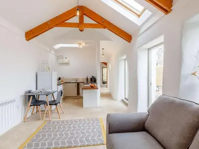 a living room with a couch and a kitchen at 1 Bed in Redruth oc-85826 in Gwennap