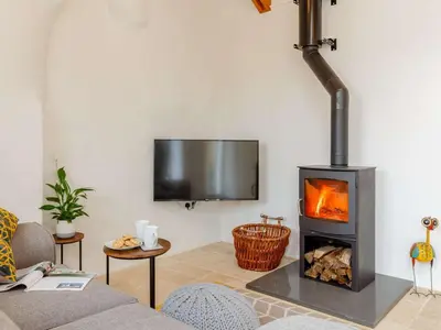 a living room with a fireplace and a tv at 1 Bed in Redruth oc-85826 in Gwennap