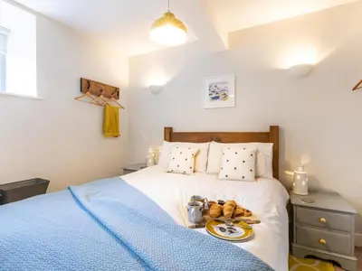 a bedroom with a bed with a tray of teddy bears on it at 1 Bed in St. Austell oc-42194 in Charlestown