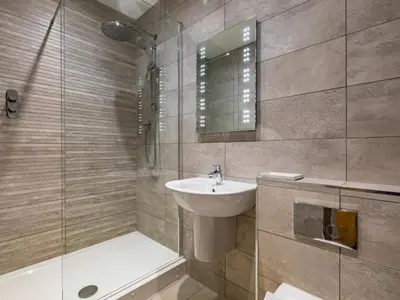 a bathroom with a sink and a shower and a toilet at 1 Bed in St. Austell oc-42194 in Charlestown