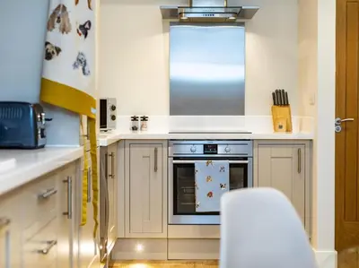 a kitchen with white cabinets and an oven at 1 Bed in St. Austell oc-42194 in Charlestown