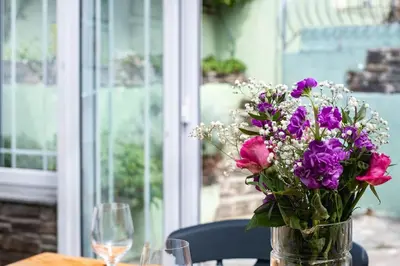 a vase filled with purple flowers sitting on a table at Harewood, Port Isaac Bay Holidays in Port Isaac