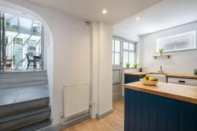 a kitchen with blue cabinets and a counter top at Harewood, Port Isaac Bay Holidays in Port Isaac
