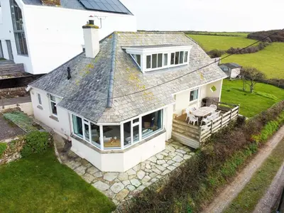 an overhead view of a white house with a roof at Trevarthian in Polzeath