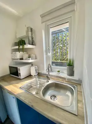 a kitchen counter with a sink and a window at Casa Studio in St Ives