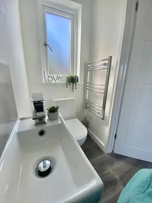 a white bathroom with a toilet and a sink at Casa Studio in St Ives