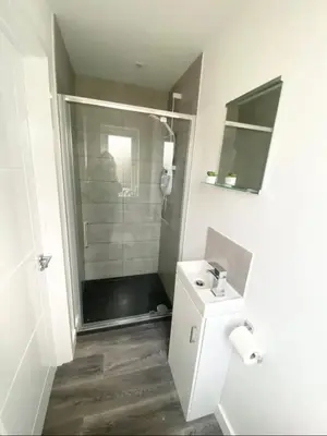 a bathroom with a shower and a toilet and a sink at Casa Studio in St Ives