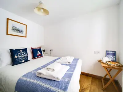 a bedroom with a bed with towels on it at Stanley House in Port Isaac