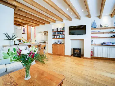 a living room with a vase of flowers on a table at Stanley House in Port Isaac