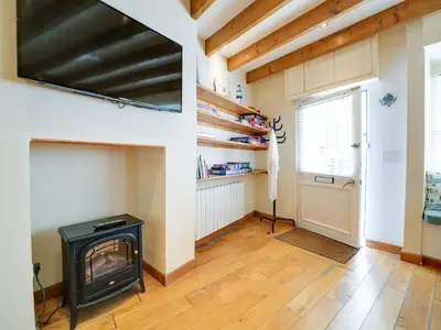 a living room with a stove in a room at Stanley House in Port Isaac