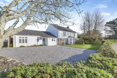 a white house with a gravel driveway at 4 Bed in St. Merryn oc-e28379 in St Merryn