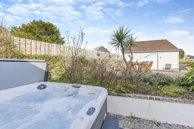 a jacuzzi tub in a yard with a house at 4 Bed in St. Merryn oc-e28379 in St Merryn