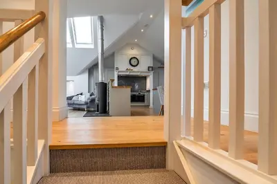 a view of the living room and kitchen from the hallway of a house at Finest Retreats - Dingles Cottage in Philleigh