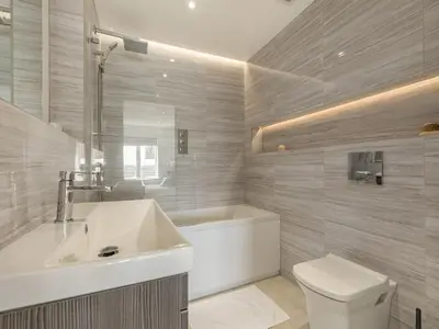 a bathroom with a sink and a tub and a toilet at The Vista in Newquay