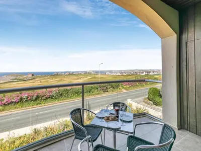 a table and chairs on a balcony with a view of a road at The Vista in Newquay
