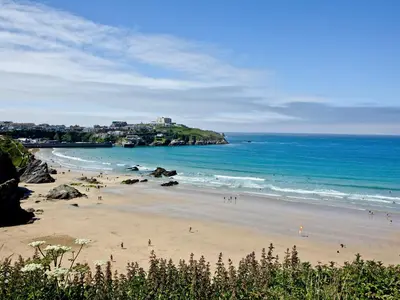 a group of people on a beach near the ocean at The Vista in Newquay
