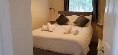 a bedroom with a bed with white sheets and pillows at 11 Granite Henge in Pelynt