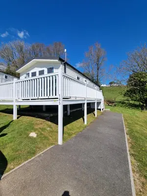 a white house with a large white deck at Seaside View Caravan in Polperro in Looe