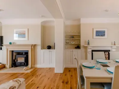 a living room with a table and a fireplace at 4 Bed in Polruan oc-pc044 in Fowey