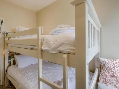 a bedroom with two bunk beds and a staircase at 4 Bed in Polruan oc-pc044 in Fowey