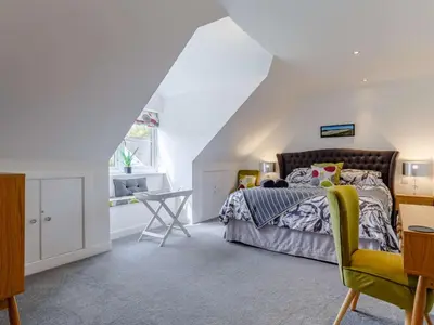 a bedroom with a bed and a desk and a window at 5 Bed in Redruth oc-65745 in Gwennap