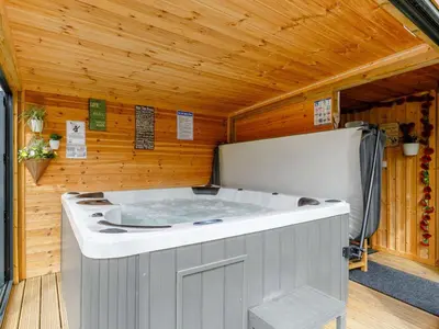 a hot tub in a room with a wooden ceiling at 5 Bed in Redruth oc-65745 in Gwennap