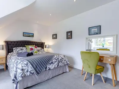 a bedroom with a bed and a desk and a window at 5 Bed in Redruth oc-65745 in Gwennap