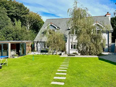 a house with a lawn with a pathway at 5 Bed in Redruth oc-65745 in Gwennap