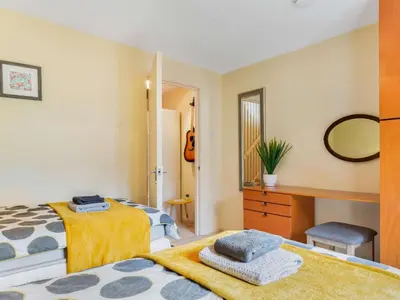a bedroom with two beds and a mirror at 2 Bed in Fowey oc-75740 in Polruan