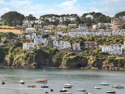 a group of boats on a body of water with houses at 2 Bed in Fowey oc-75740 in Polruan