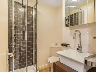 a bathroom with a toilet and a sink and a shower at 2 Bed in Fowey oc-75740 in Polruan