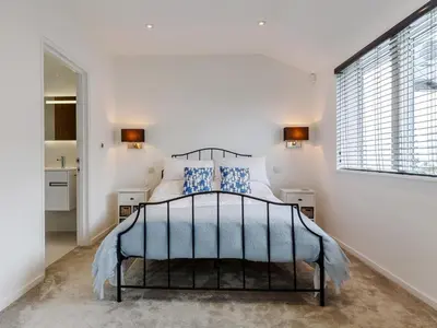 a bedroom with a bed and a large window at 5 Bed in Fowey oc-77657 in Polruan