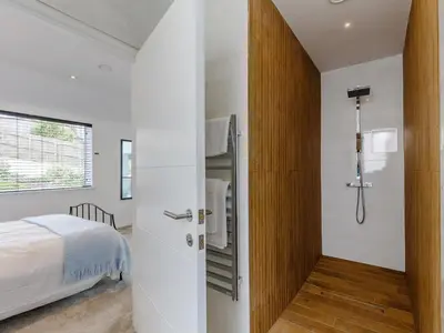 a bedroom with a door leading to a bed at 5 Bed in Fowey oc-77657 in Polruan