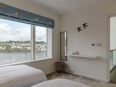 a bedroom with a window with a view of the water at 5 Bed in Fowey oc-77657 in Polruan