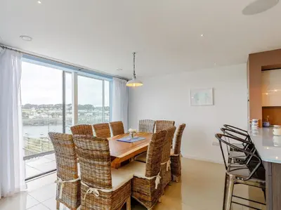 a dining room with a table and chairs and a window at 5 Bed in Fowey oc-77657 in Polruan