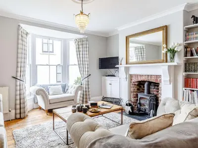 a living room with a couch and a fireplace at 3 Bed in Fowey oc-82101 in Fowey