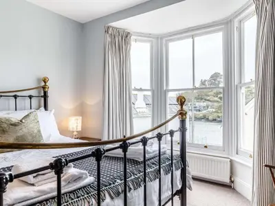 a bedroom with a bed and a large window at 3 Bed in Fowey oc-82101 in Fowey
