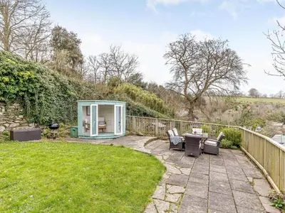 a garden with a greenhouse and a table and chairs at 3 Bed in Fowey oc-82101 in Fowey