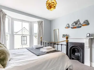 a bedroom with a bed and a fireplace at 3 Bed in Fowey oc-82101 in Fowey