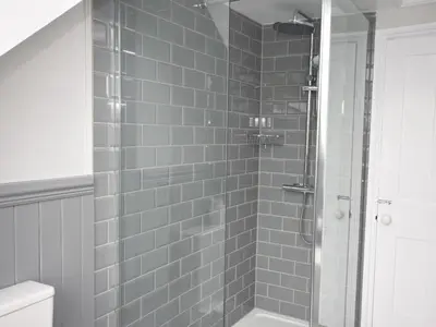 a bathroom with a shower with gray tiles at 3 Bed in Fowey oc-82101 in Fowey