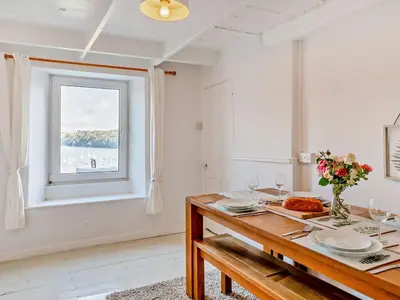 a dining room with a table and a window at 3 Bed in Polruan oc-83821 in Fowey